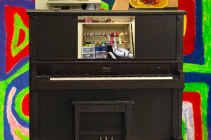 Photo of piano and art supplies.