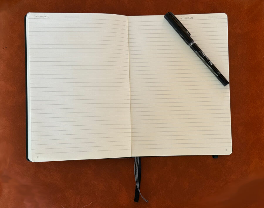 photo of a blank journal and pen